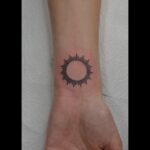 small geometric sun on the wrist tattoo