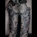 Black and grey Lion and pocket watch tattoo realism