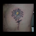 Line work daisy tattoo with yellow middle
