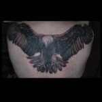 Large black and grey eagle tattoo o the back