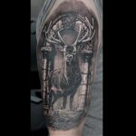 Black and grey Stag and stone arch realistic tattoo