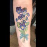 Violet flower tattoo in colour