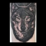 Realistic wolf portrait tattoo